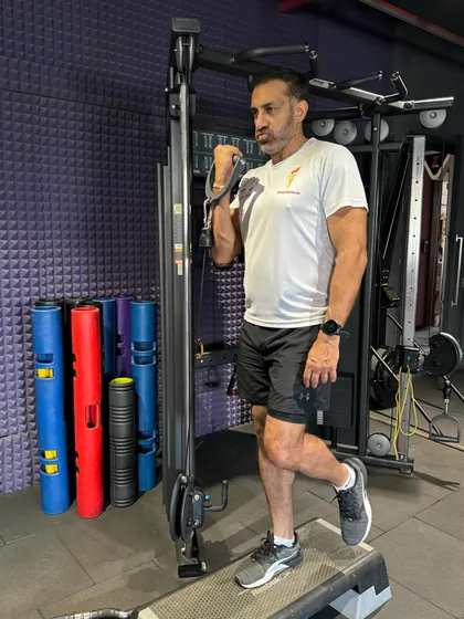 Using the cable machine for a targeted bicep curl. Our studio is equipped with a wide range of machines to help you isolate and strengthen specific muscle groups.