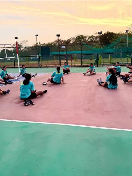 Post-practice recovery is essential. Our girls' team stretching on the court after a tough training session for the Shanghai tournament.