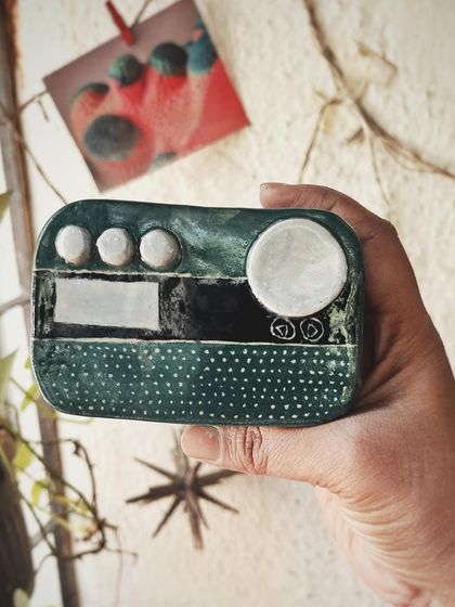 This student started with a one-time workshop and came back to begin his pottery journey. His pieces, like the quirky radio and the massive planter, are full of fun and character.