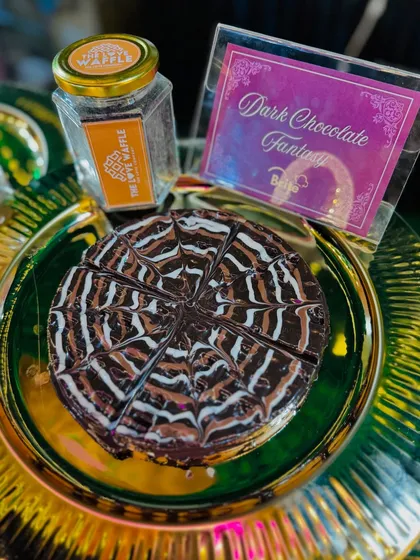 A "Dark Chocolate Fantasy" waffle, sliced and ready for sharing, showcasing the rich chocolate topping.