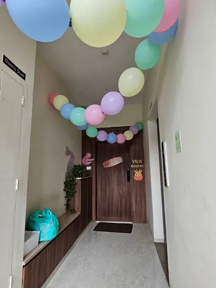 A simple yet festive way to welcome guests. A colorful pastel balloon garland leads the way to the front door of the party residence.
