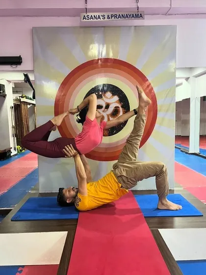 A variation of the Throne pose in acro yoga, where the flyer moves into a backbend. This requires significant core strength from the base and flexibility from the flyer.
