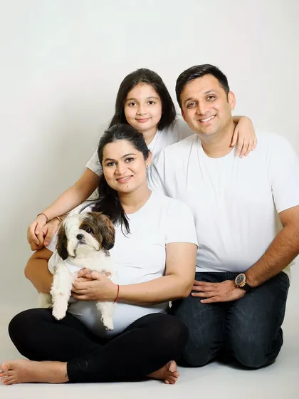 Family is everything, and that includes our pets. This lovely family portrait from a maternity session includes their adorable dog, making it a complete family picture.