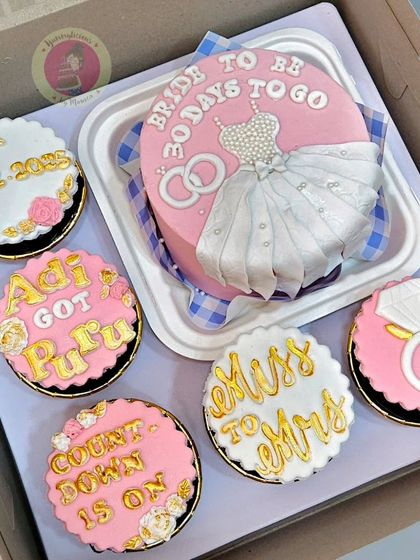 A "Bride to Be" bento cake and matching cupcakes, perfect for a countdown celebration. The set includes details like "30 days to go" and "Miss to Mrs".
