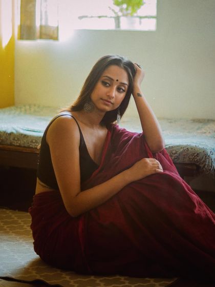 A candid, thoughtful moment captured during a photoshoot, reflecting the introspective nature of my work.