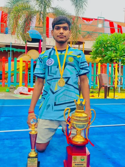 One of my star players showcasing his individual and team trophies after a winning performance.