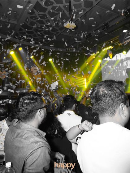 A confetti blast during the peak of the party. Moments like these, with yellow lights flooding the room, create a euphoric atmosphere that makes any celebration unforgettable.