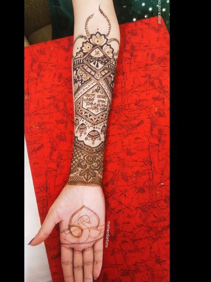 This design incorporates a special blessing written in Hindi script, along with sacred symbols like the lotus and swan, making it a truly spiritual and personal mehandi.