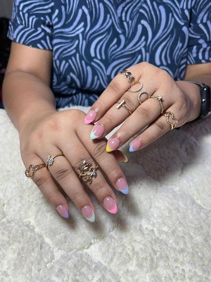 A playful pastel rainbow French manicure. This is a fun, youthful design that is perfect for summer.