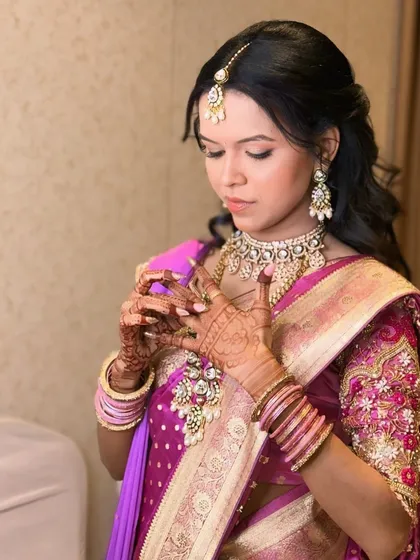 Adjusting her ring, this candid photo shows the detailed henna and the soft glam makeup that lasts through all the rituals.