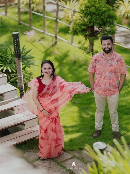 Another high-angle view, capturing her flowing saree and their happy stance.