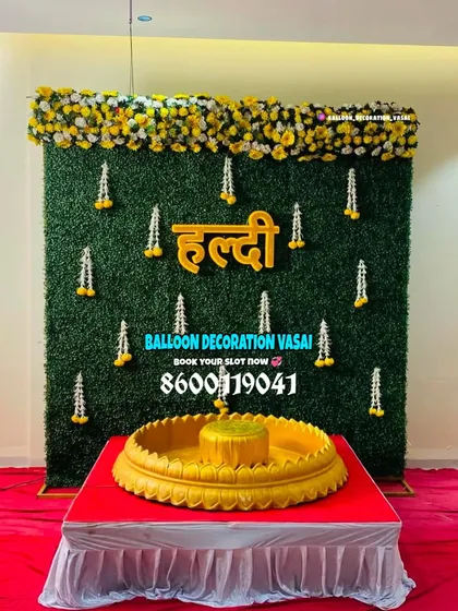 We can blend modern and traditional elements, like this grass wall backdrop paired with a classic brass `urli` for the Haldi ceremony rituals.