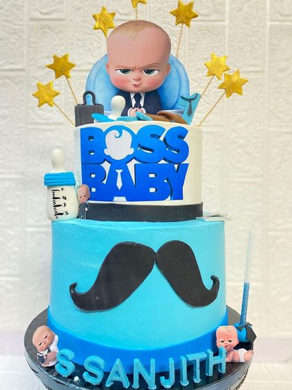 Our popular Boss Baby theme, perfect for a little one turning one. This two-tier butterscotch cake is all business, decorated with a pacifier, briefcase, and a moustache.
