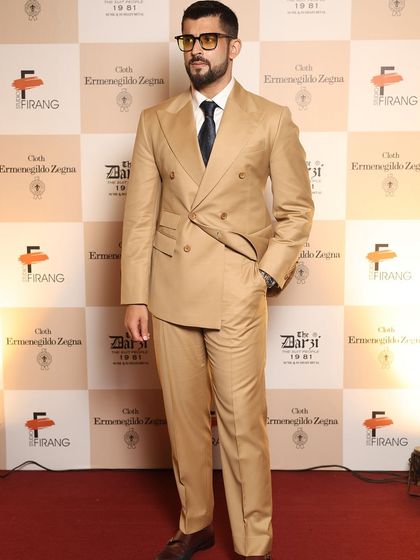 A guest showcasing timeless style in a bespoke double-breasted camel suit. This look exemplifies the sophisticated and confident aesthetic we create for our clients.