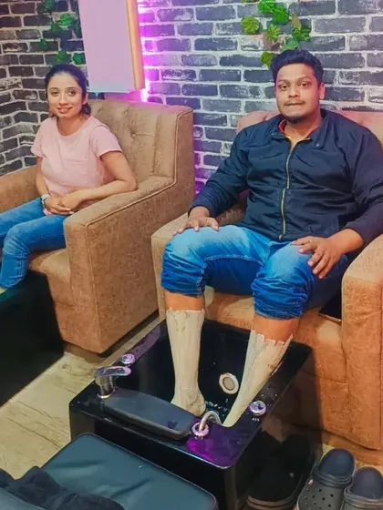 A couple enjoying a relaxing pedicure treatment side-by-side at our salon.