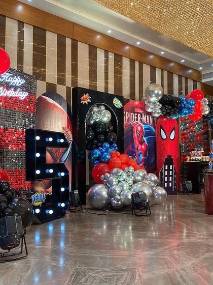 Another angle of the grand Spider-Man celebration, highlighting the balloon arrangements and the different themed stations for desserts and photos.