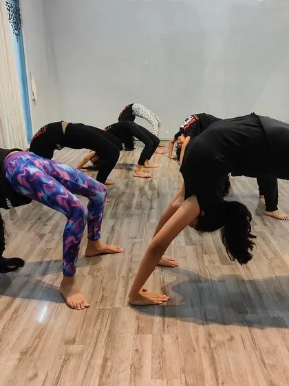 Dancers working on their flexibility and strength. Our studio is equipped to support various forms of dance and fitness training.