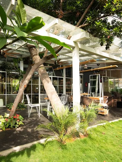 For Enrich Salon in Bangalore, we preserved an old bungalow and its lush greenery to create a therapeutic retreat. The design blurs the line between indoors and outdoors, with semi-open styling areas that embrace the pleasant weather and connect clients with nature.