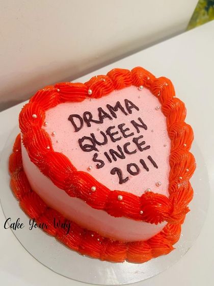 A sassy heart-shaped cake for the "Drama Queen Since 2011."