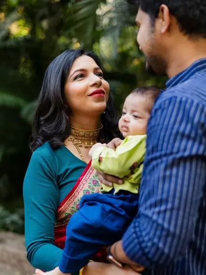 A mother's loving gaze at her newborn baby during his naming ceremony. These candid, emotional shots are just as important as the posed portraits.