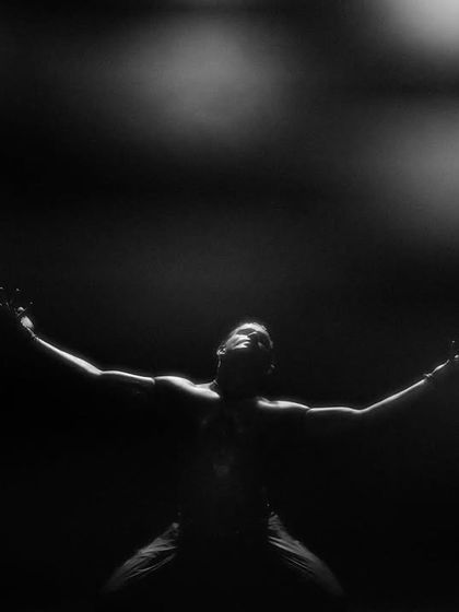 A black and white shot from 'Nagamandala', capturing a moment of surrender and power. The use of smoke adds to the ethereal atmosphere.