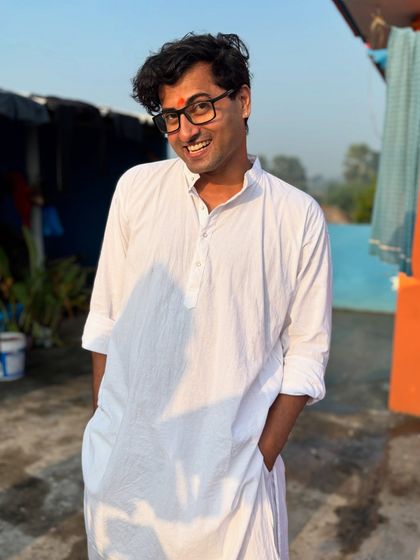 A simple white kurta and a big smile. This is me, relaxed and happy, soaking in the festive vibes.