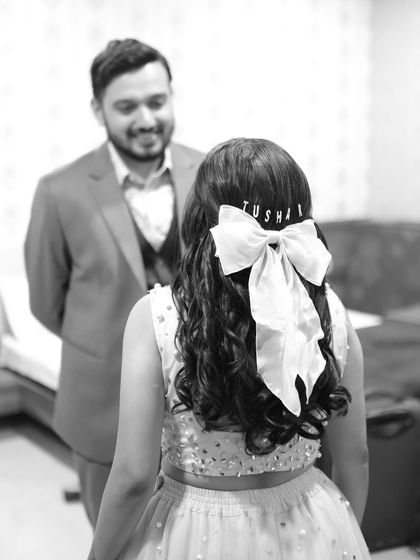 A sweet "first look" moment. The personalized bow in her hair is such a cute detail, and her makeup is perfectly soft and romantic.