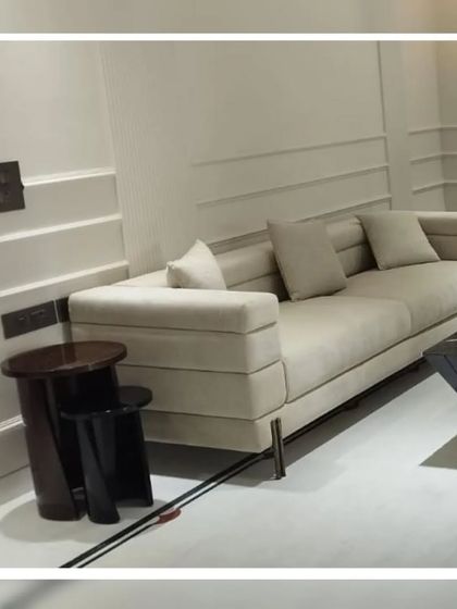 A minimalist sofa with a unique tiered design, offering a contemporary and architectural feel. This piece is perfect for modern spaces, providing clean lines and a structured yet comfortable seating solution.