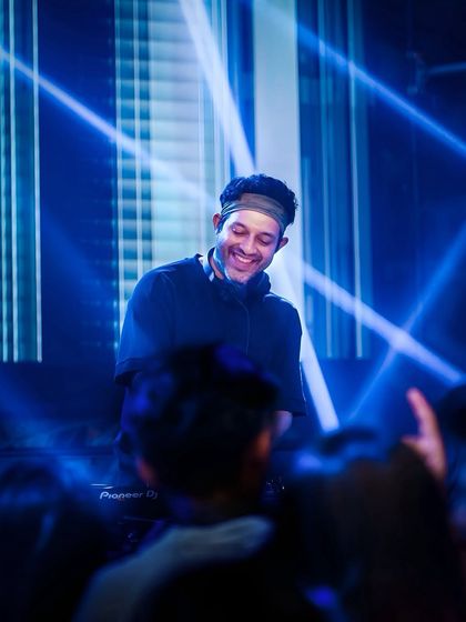 Another shot of me at the console, with the stage lights creating a cool effect. The production quality at my events is always top-notch.