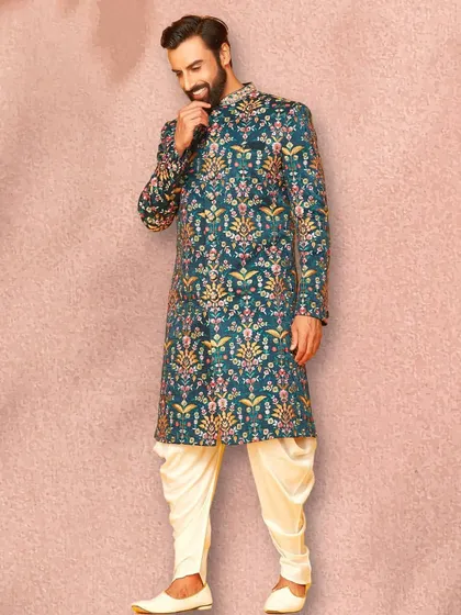 A side profile of the beautiful teal sherwani, showing how the pattern flows across the entire garment. Paired with cream dhoti pants, it's a balanced and stylish look.