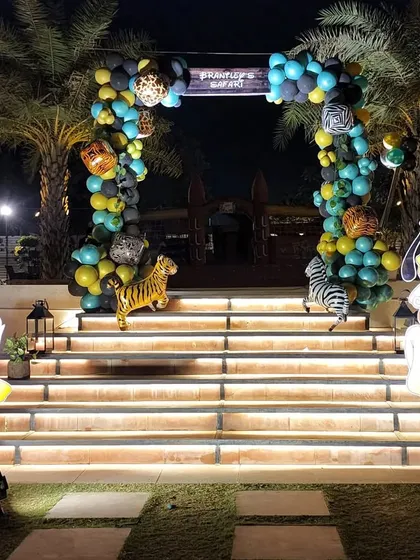 A grand entrance to a safari party, with the venue's steps flanked by large cutouts of Donald Duck and Pluto in safari gear. This creates an exciting welcome for the young guests.