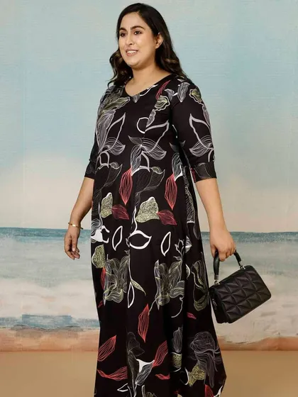 This black A-line dress for plus-size women is one of my favorites for its elegant and modern feel. The abstract floral pattern adds a touch of artistry, making it a sophisticated choice for any occasion.