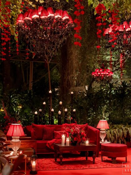 This seating arrangement from 'Laal Bagh' showcases the deep, monochromatic red palette. The plush velvet sofas, dramatic floral chandeliers, and abundant candlelight created a space that was both comfortable and incredibly glamorous.