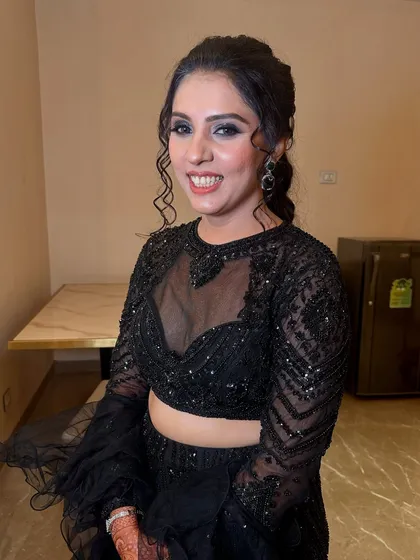 Glamorous smoky eyes and a glossy nude lip add drama to this all-black ensemble, creating a look that is pure elegance with an edge.