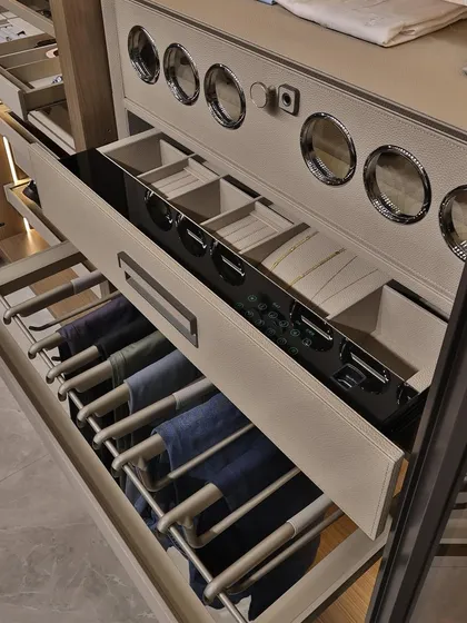 This close-up shows the specialized storage solutions I incorporate, like pull-out trouser racks and sectioned drawers for watches and small accessories. It’s these details that define a luxury wardrobe.