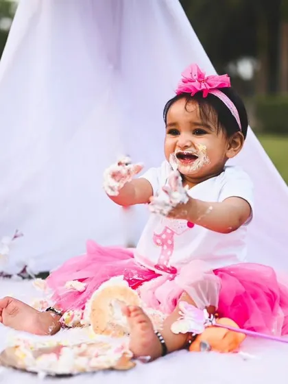 Let the fun begin! A cake smash session is the perfect way to celebrate a first birthday. I set up this outdoor teepee scene and let this little one enjoy her cake, capturing her pure, messy joy.