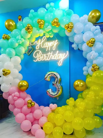 A bright and happy rainbow-colored balloon ring for a 3rd birthday. The simple and colorful design is perfect for any space and creates a joyful atmosphere.