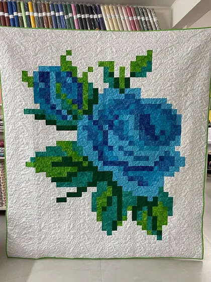 A modern take on a classic floral, this Pixelated Rose quilt showcases how our longarm quilting can add texture and definition to contemporary patchwork designs, making the pixel art truly pop.