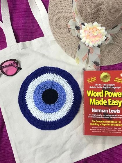 I designed this canvas tote bag with a large crochet evil eye emblem to bring good vibes only. It's a stylish way to carry your essentials while warding off negativity.