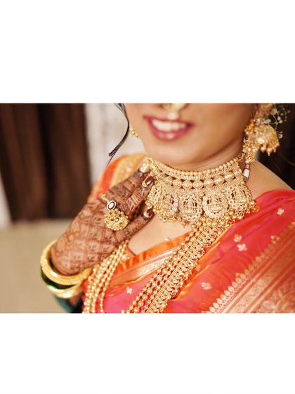 A close-up detail shot of the bride's stunning temple jewelry necklace.