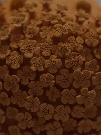 Here is the floral vase after its first firing, known as a bisque. The intricate details of the unglazed clay flowers are so beautiful on their own, it almost feels a shame to glaze it.