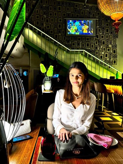 A dinner date look featuring a white ruched top and a navy midi skirt. This is a classic and elegant combination that is always in style.