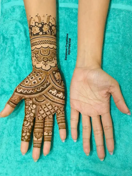 One hand adorned, one hand bare. This shot perfectly captures the transformative power of bridal mehndi.