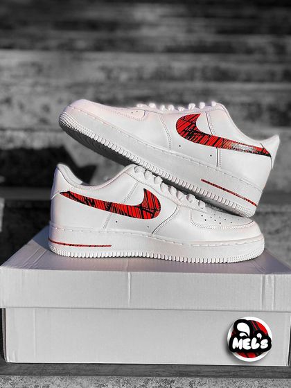 A full product shot of the MotoGP custom Nikes on their box.