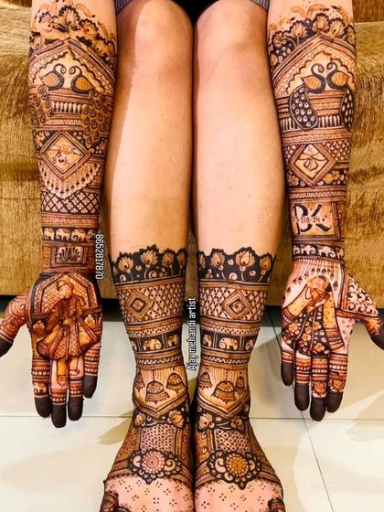 A complete view of the bridal mehndi on hands and feet. The patterns are consistent, creating a full and rich look for the bride.