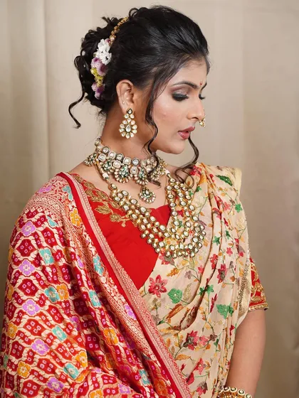 This side profile showcases the intricate texture and floral arrangement of the messy khopa. I use a combination of fresh flowers and a traditional hair pin to create a balanced and beautiful design.