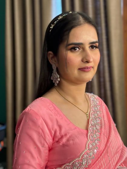 A lovely client ready for a party in a pink saree. The makeup is soft and pretty, with pink tones on the eyes and lips to match her outfit.