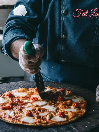 Every pizza I make is a handcrafted masterpiece. Here, I’m slicing up a classic margherita, fresh from the oven and ready to be served.