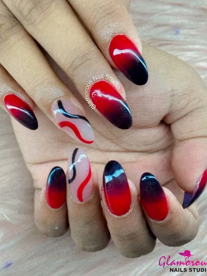 For those who love a bold and dramatic look, this red-to-black ombre is a showstopper. We blended the colors seamlessly on long almond-shaped nails and added abstract swirl accents for an extra touch of modern artistry.