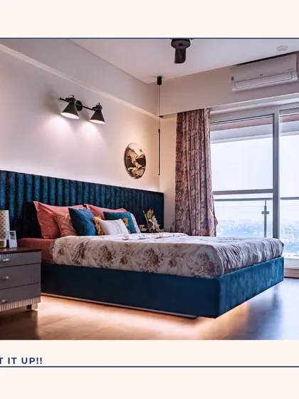 Your master bedroom should be your personal retreat. For this space, I created a dramatic and luxurious ambiance with a floor-to-ceiling velvet channel headboard, layered lighting, and large windows that offer a stunning city view.